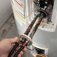 Technician testing an electric water heater heating element in Harrisburg PA