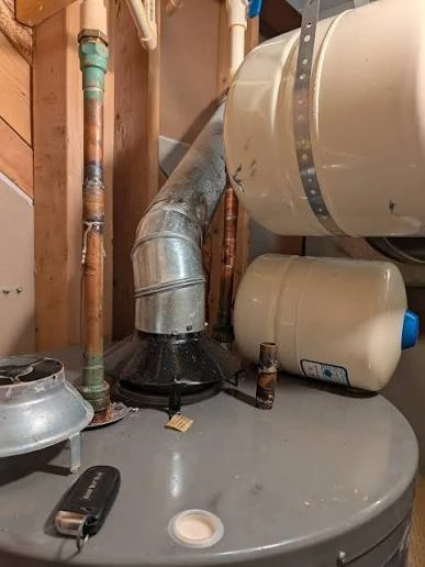 Old corroded water heater removed from a Harrisburg PA Midtown rowhome basement for replacement