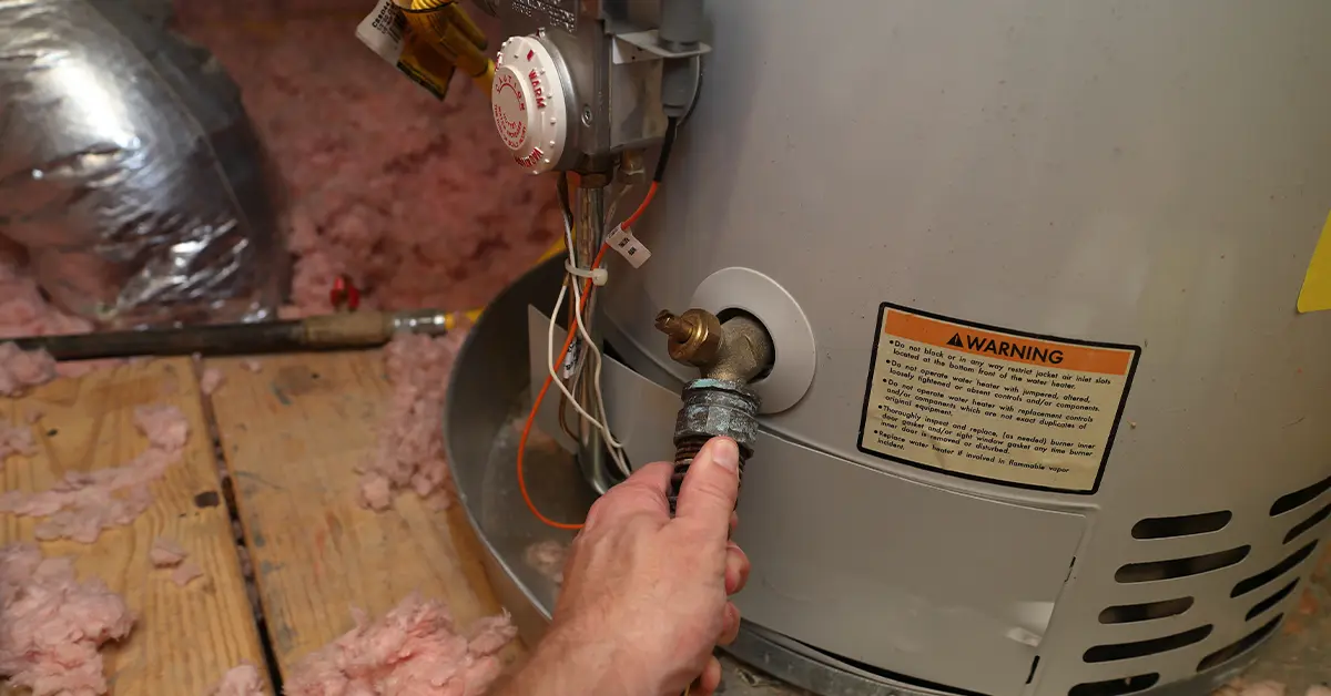 Technician performing scheduled water heater maintenance in a Harrisburg PA home